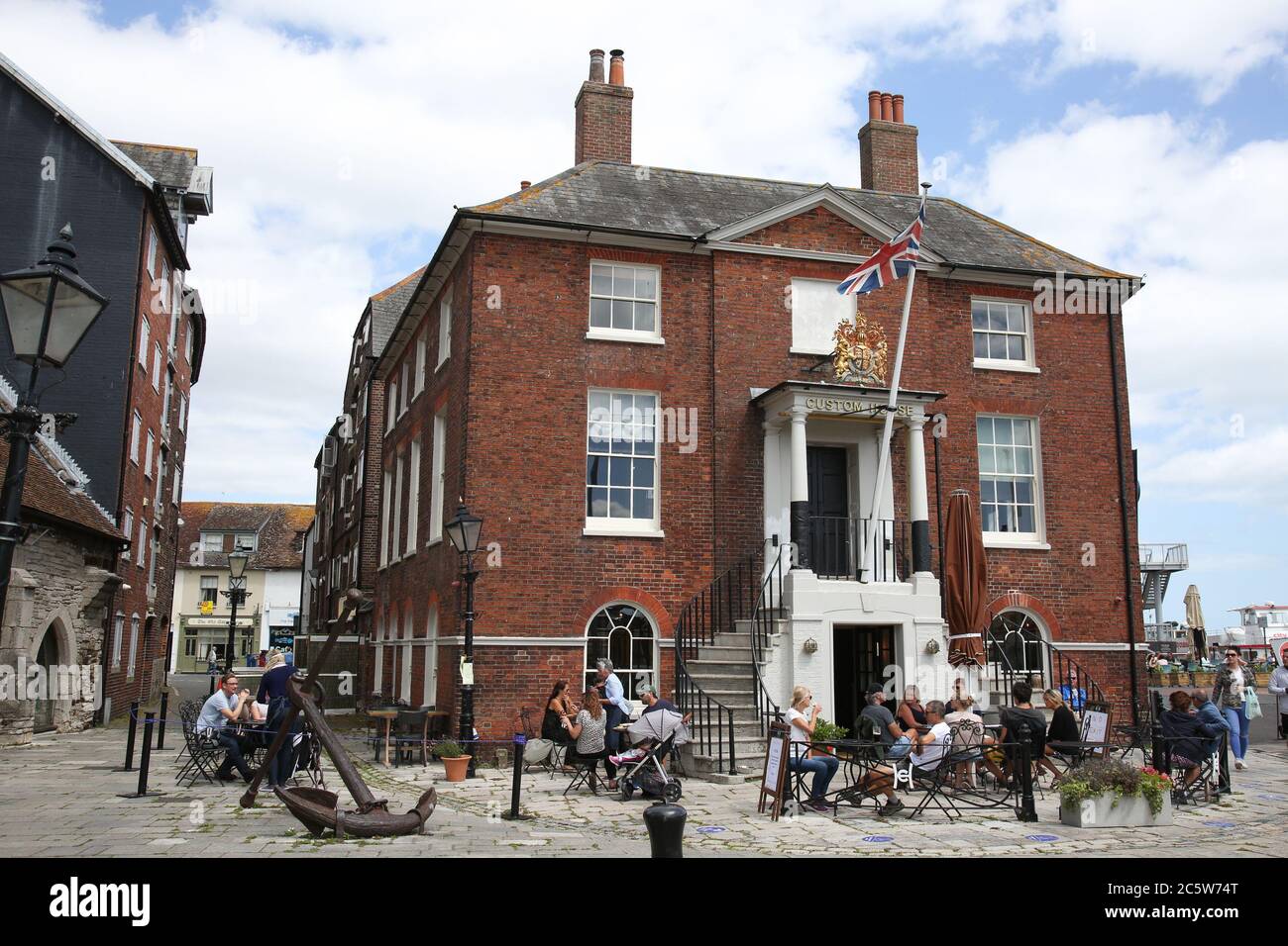 Poole, UK. 5th July 2020. The Old Custom House Cafe on Poole Quay bustling with life as cafes and pubs reopened this weekend . Credit: Richard Crease/Alamy Live News Stock Photo