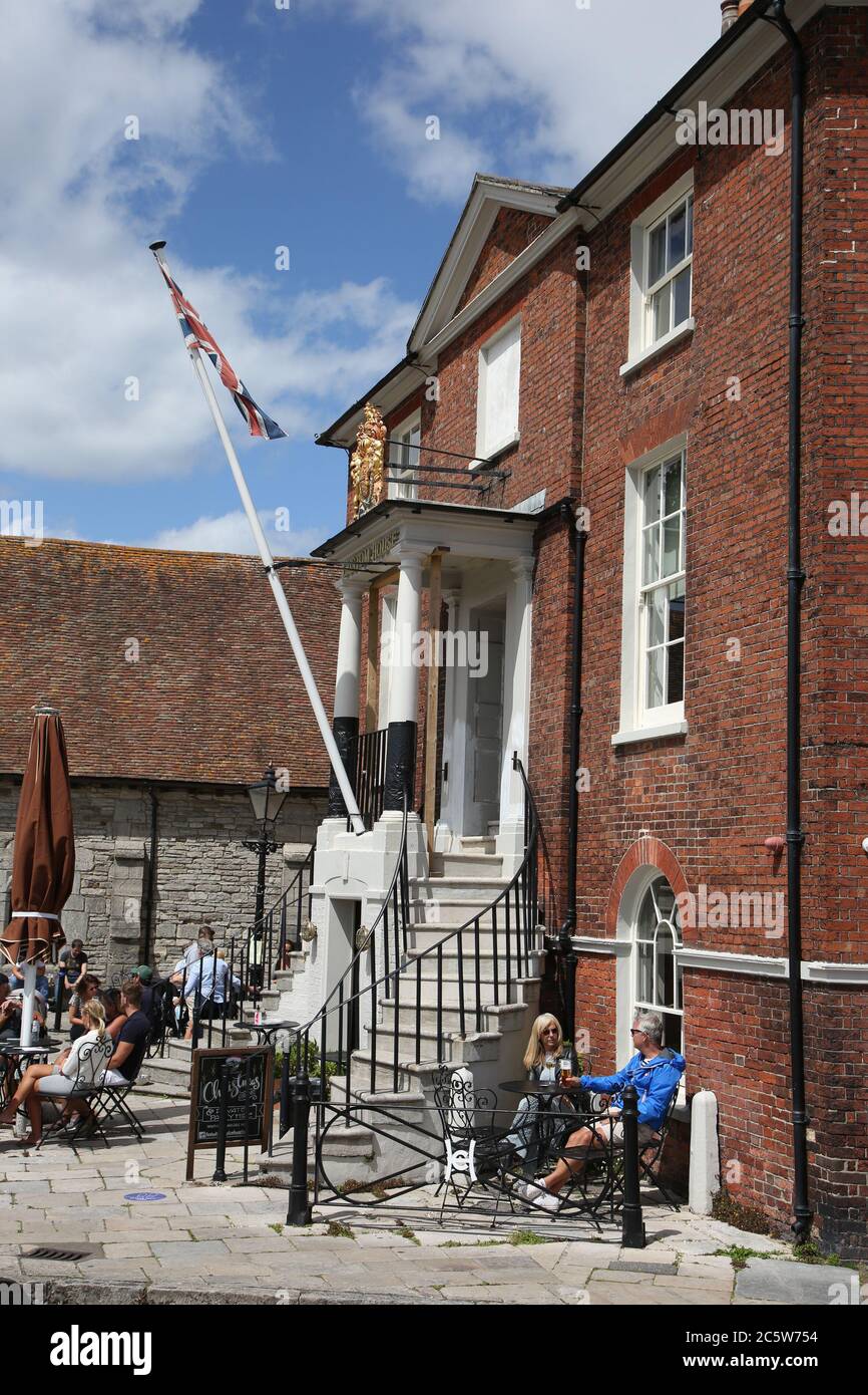 Poole, UK. 5th July 2020. The Old Custom House Cafe on Poole Quay bustling with life as cafes and pubs reopened this weekend . Credit: Richard Crease/Alamy Live News Stock Photo