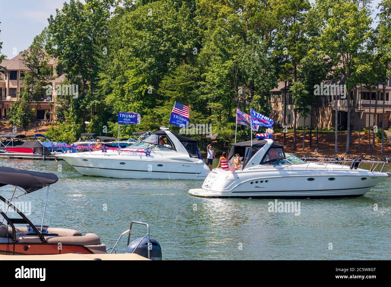 Mooresville, NC, USA - July 4, 2020: Boats flying Trump 2020 flags for President Donald Trump on Lake Norman near the Trump National Golf Club Charlot Stock Photo