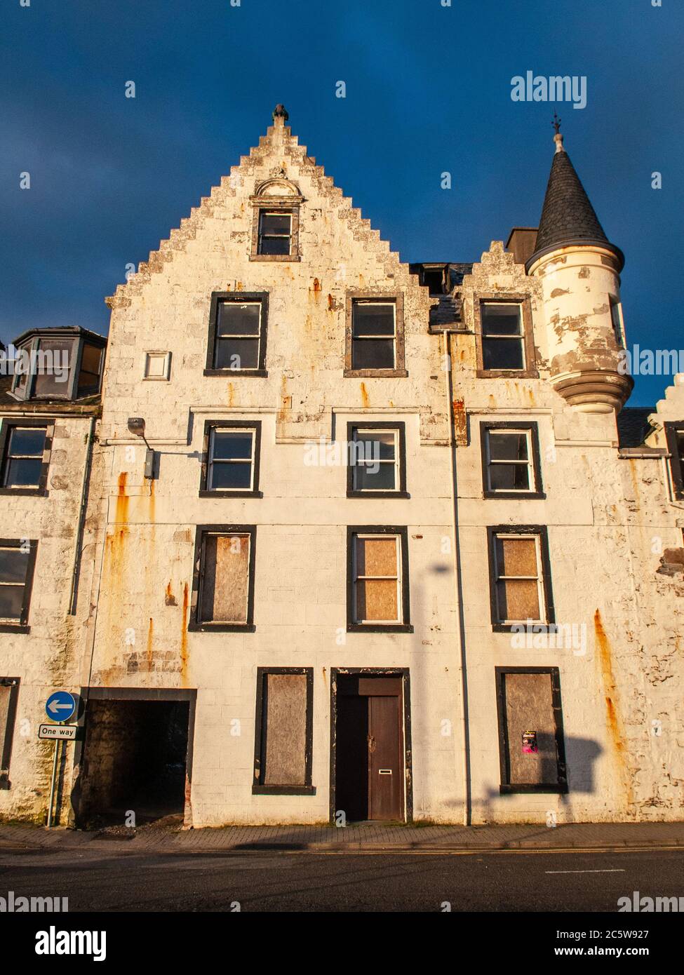 Oban, Scotland, UK  - June 3, 2011: The old Argyll Hotel stands abandoned and boarded up on the Corran Esplanade in Oban prior to its demolition. Stock Photo