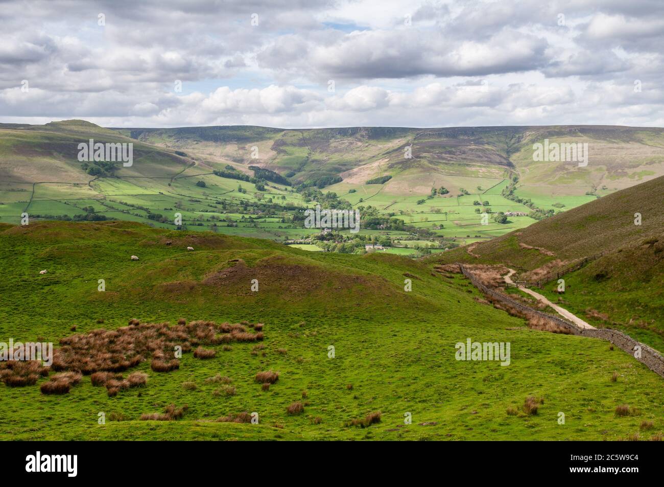 The moors of Kinder Scout rise above the Vale of Edale in Derbyshire's Peak District. Stock Photo