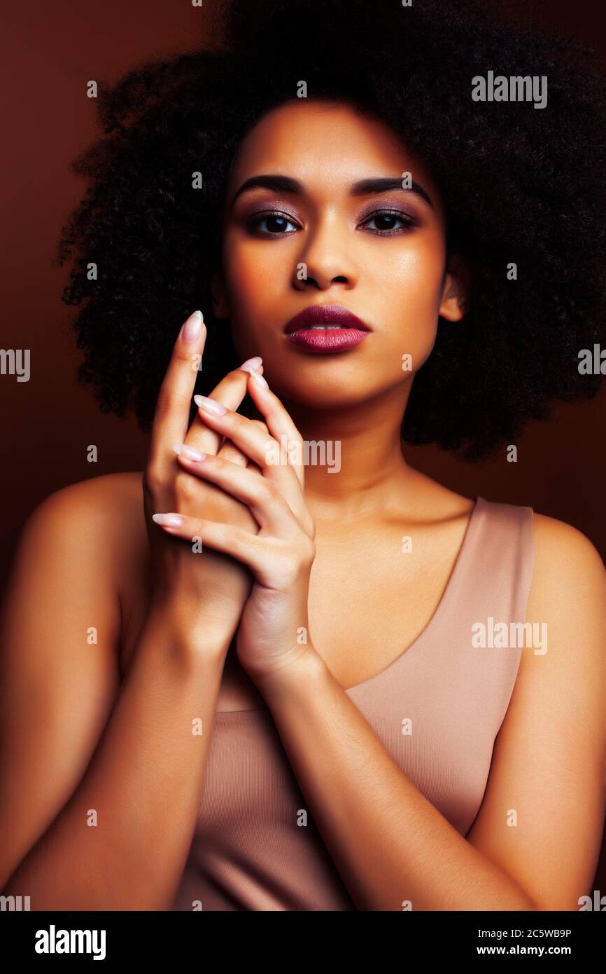 pretty young african american woman with curly hair posing cheerful ...