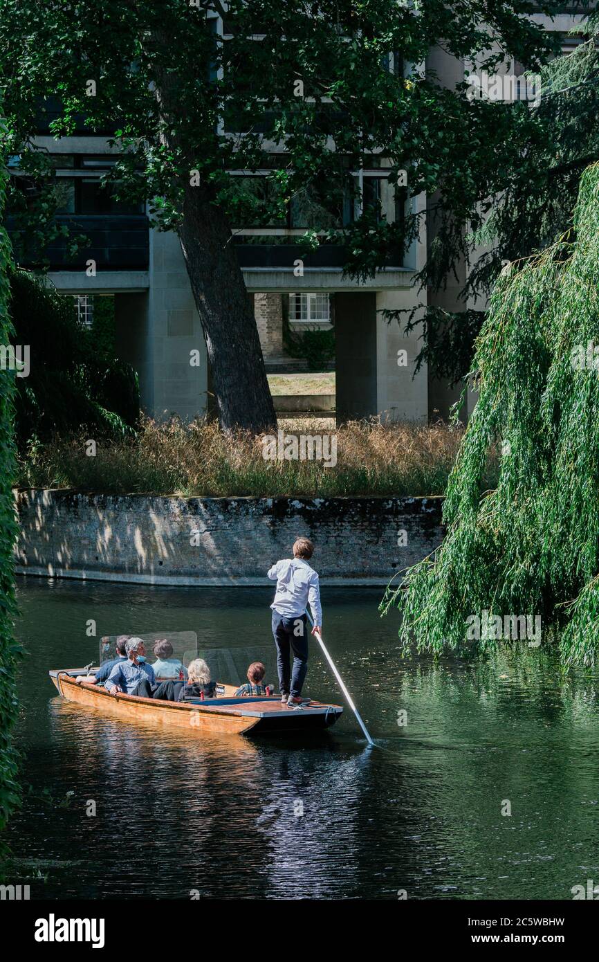 Perspex dividers are seen installed on a punt as a group chauffeured punt tour along the River Cam, Cambridge, UK. Stock Photo