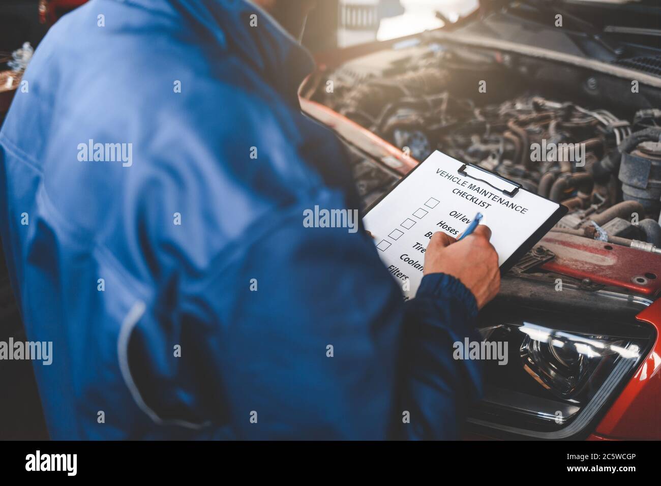 Car mechanic inspecting vehicle. Auto inspection concept Stock Photo ...