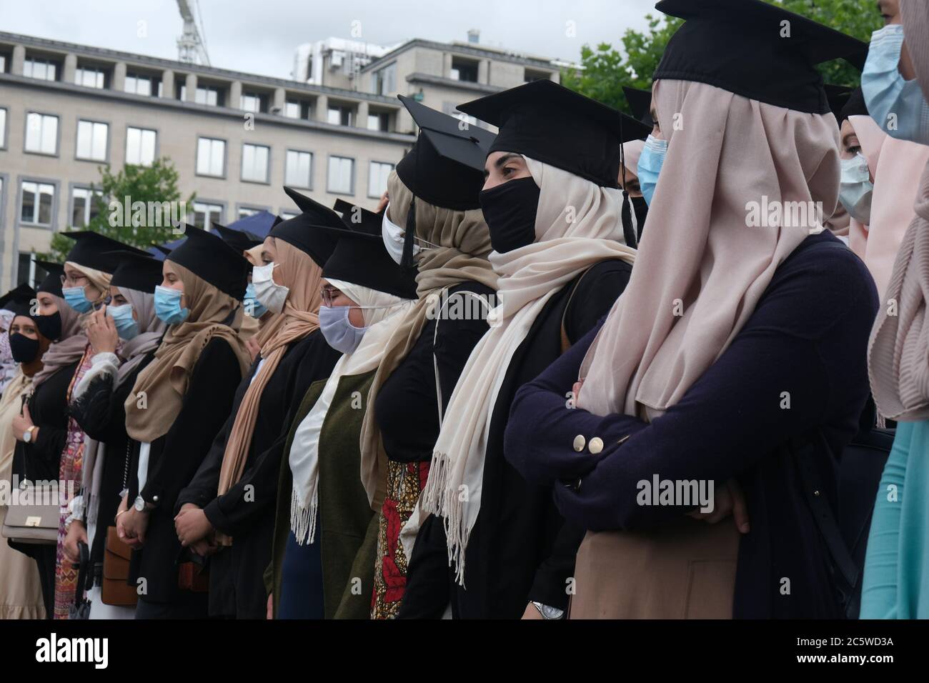 Brussels, Belgium. 5th July, 2020. Women wearing graduation hats over their  hijab during a demonstration called #