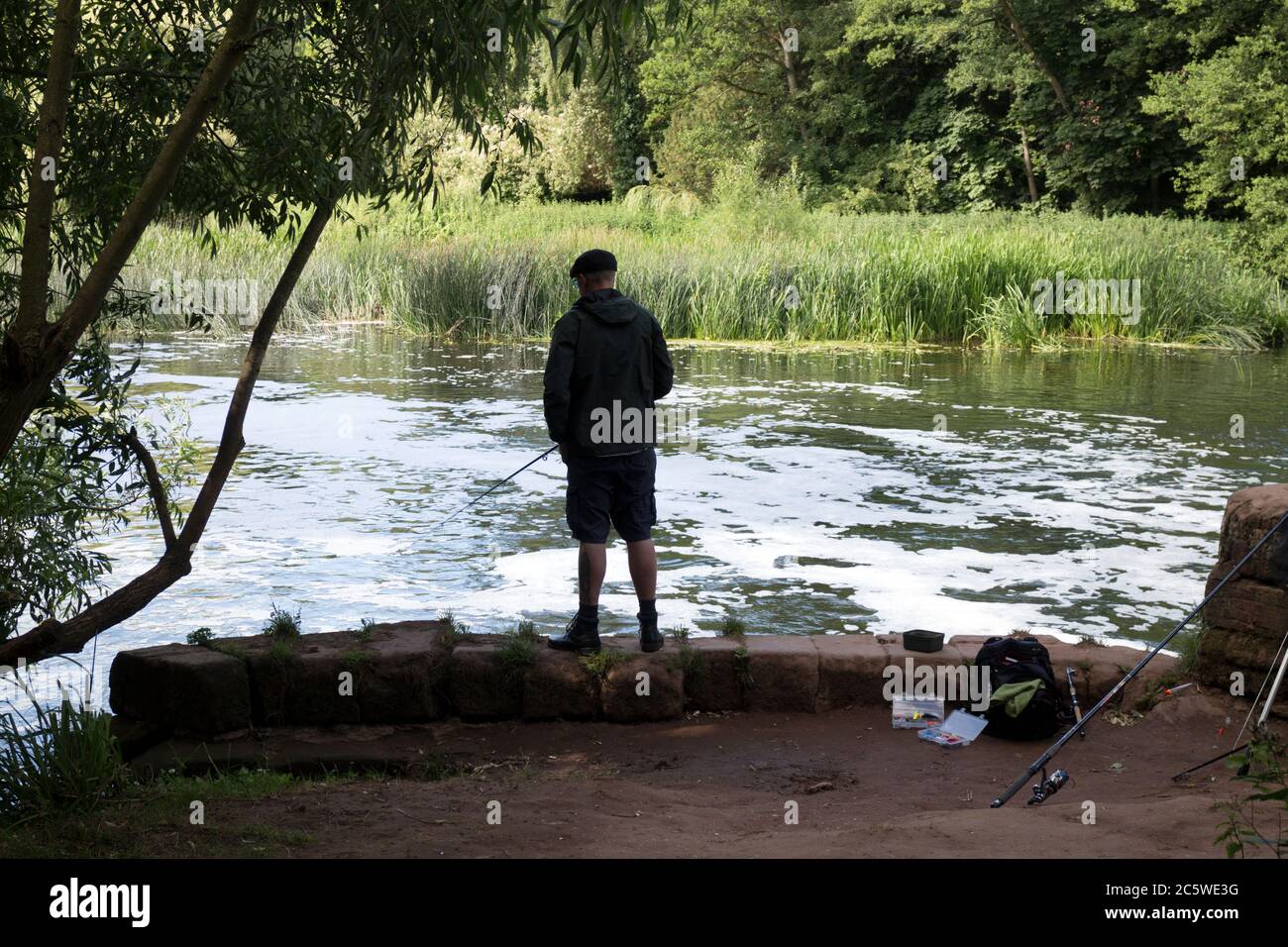 A man fishing in the River Avon at the Saxon Mill, Warwick