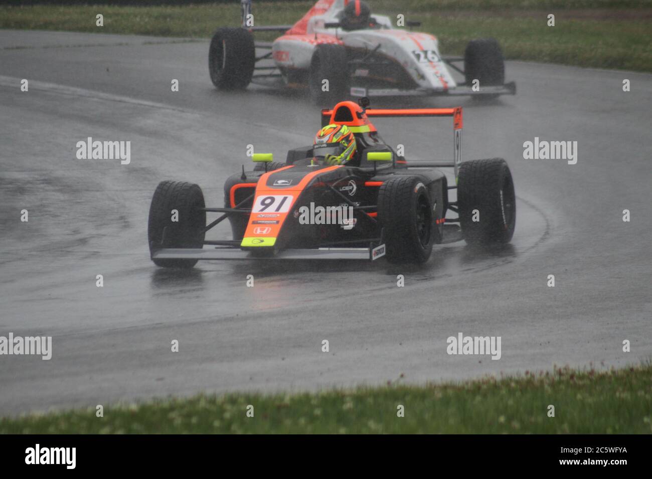 Open wheel racing in the rain at Mid-Ohio Sports Car Course Stock Photo ...