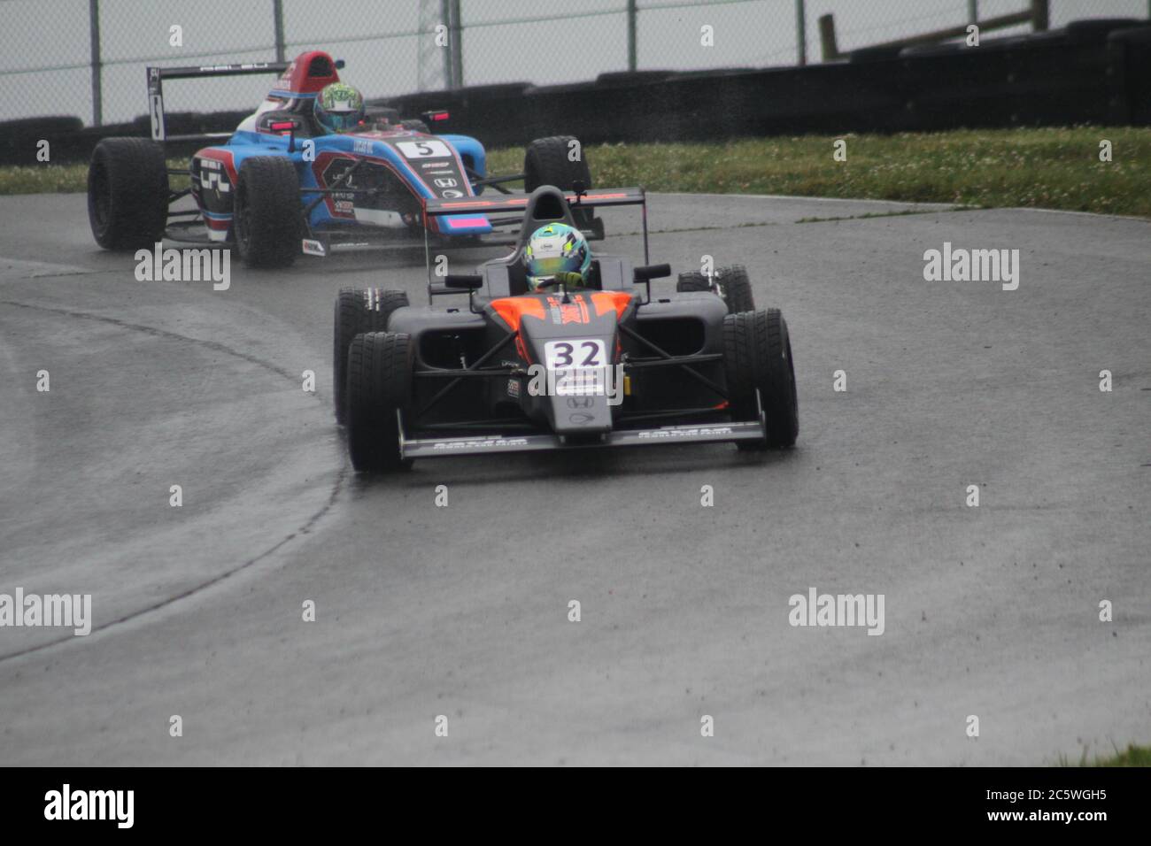 Open wheel racing in the rain at Mid-Ohio Sports Car Course Stock Photo ...