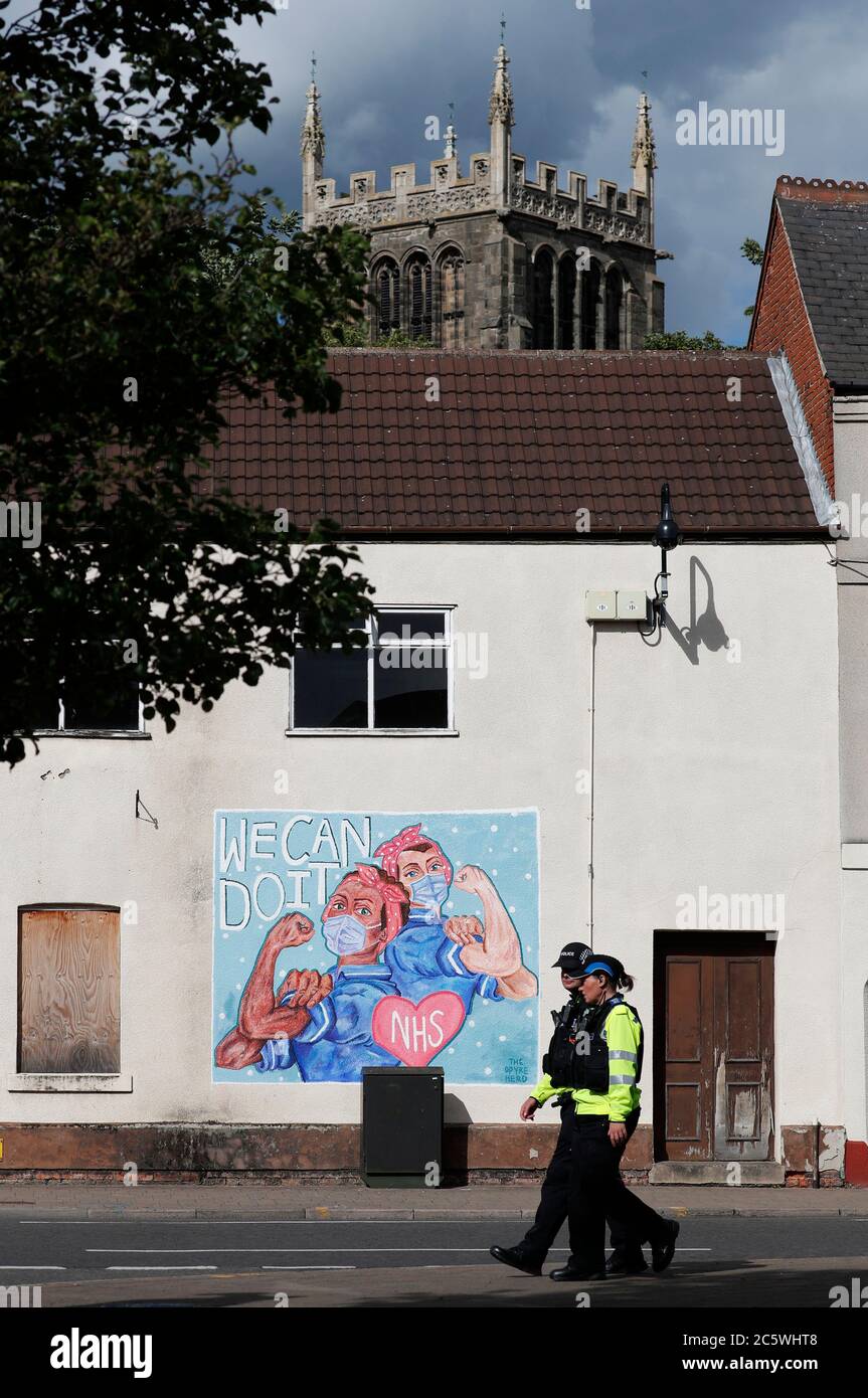Loughborough, Leicestershire, UK. 5th July 2020. Police officers walk past a mural paying tribute to the National Health Service on its 72nd anniversary during the coronavirus pandemic. Credit Darren Staples/Alamy Live News. Stock Photo