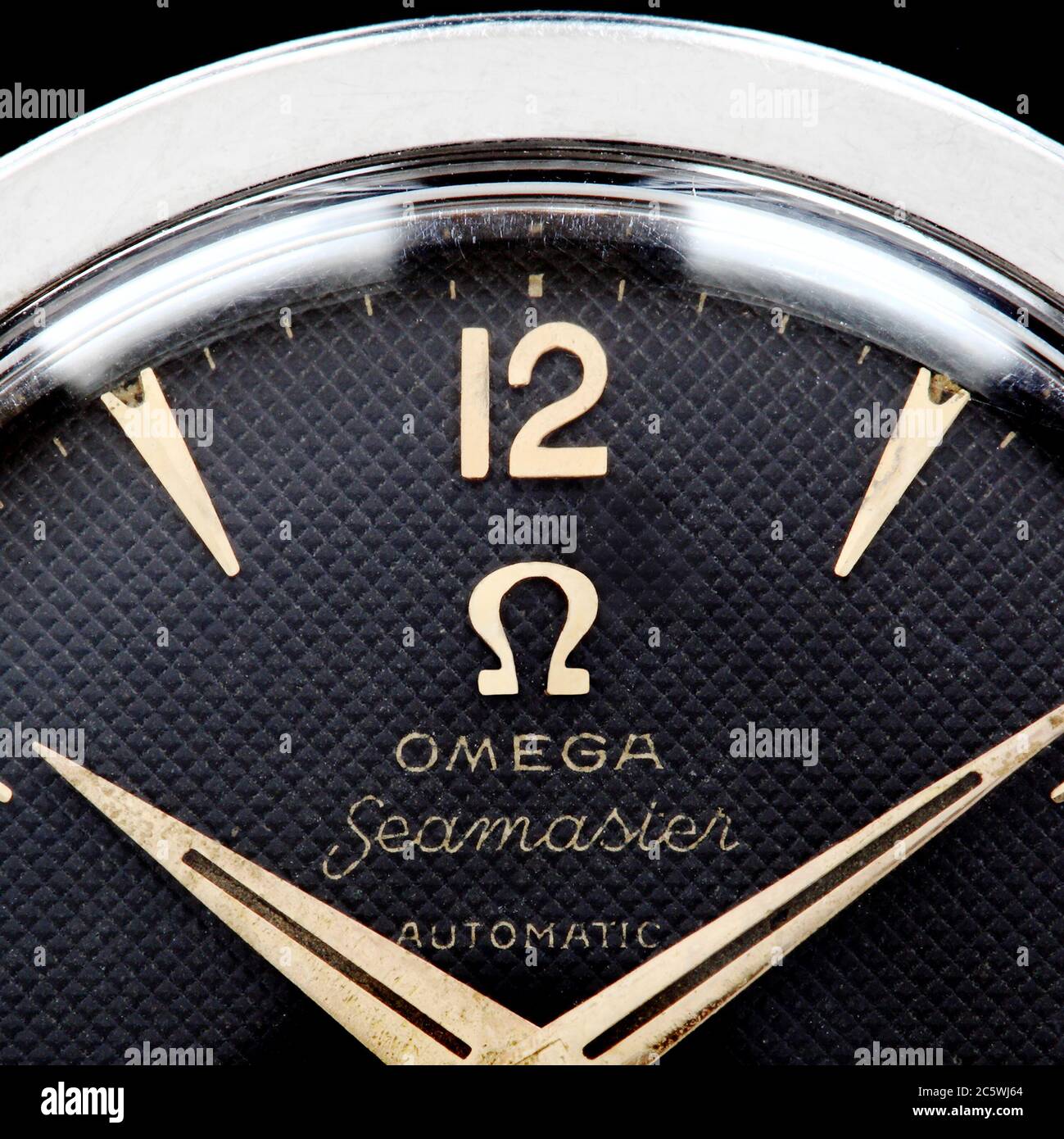 Vintage 1950s Omega Seamaster Omega logo, symbol or trademark on a honeycomb or waffle dial watch. Omega watchmaking company wristwatch. Stock Photo