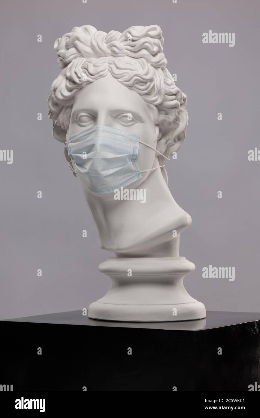 White plaster statue of a bust of Apollo Belvedere in a disposable