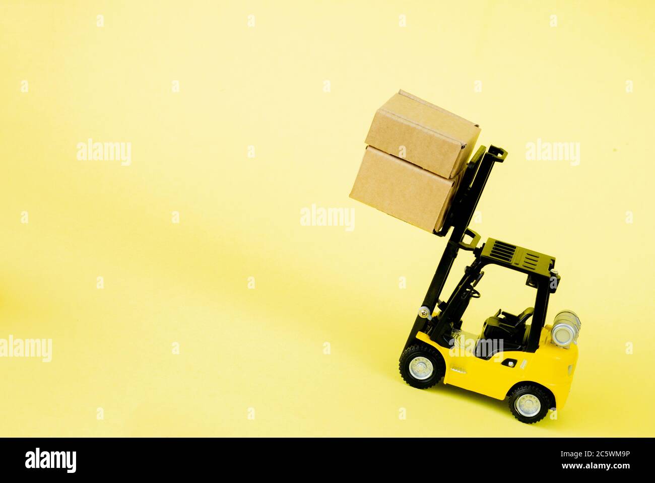 Mini forklift truck load cardboard boxes. Logistics and transportation ...