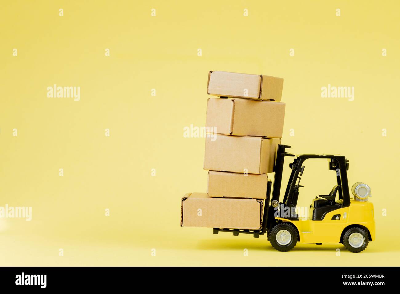 Mini forklift truck load cardboard boxes. Logistics and transportation ...
