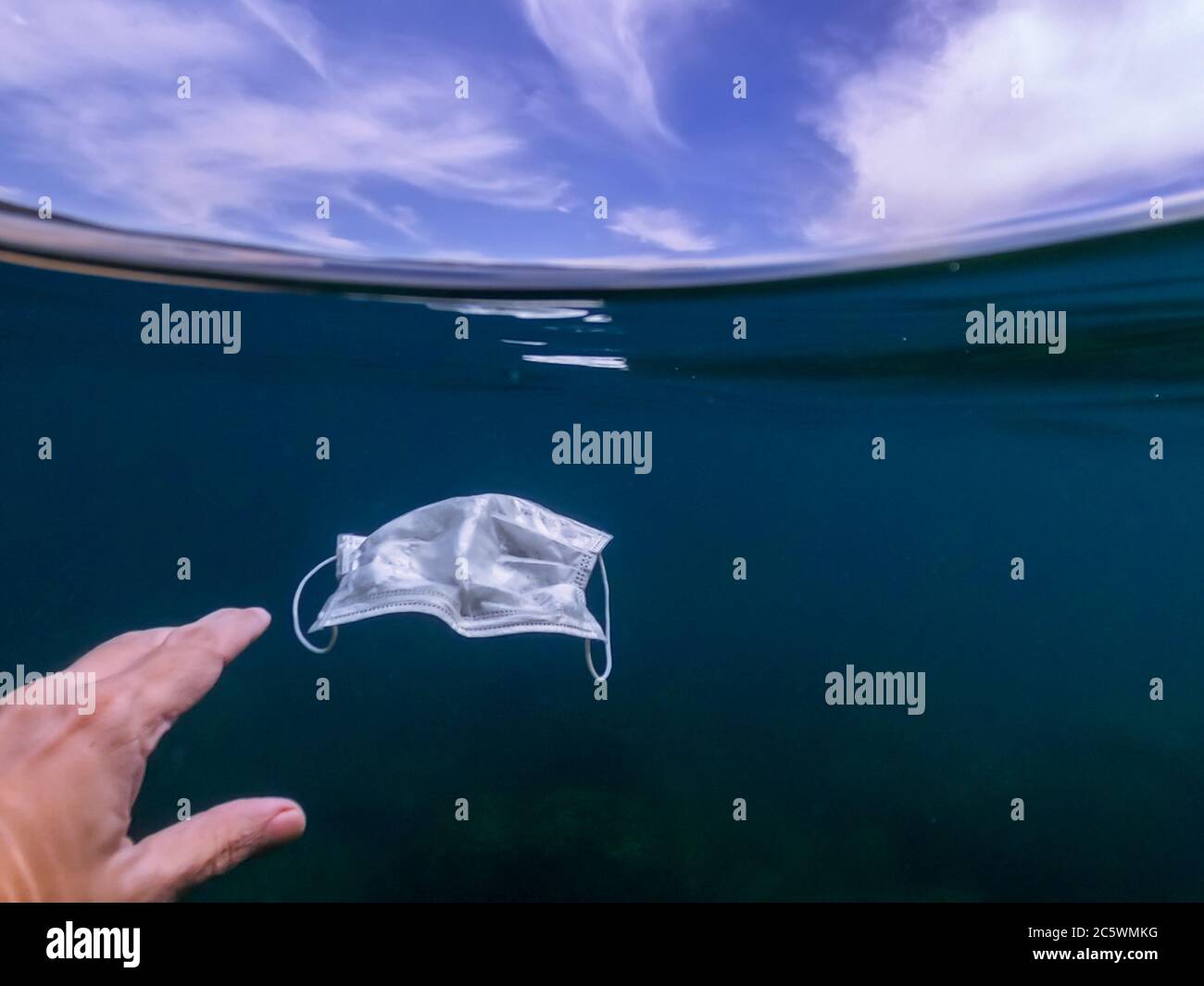 Waste during COVID19. Volunteer man snorkeler diving underwater and