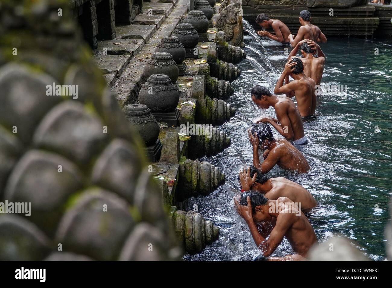 Gianyar, Bali, Indonesia. 5th July, 2020. Pilgrims wash their body into ...