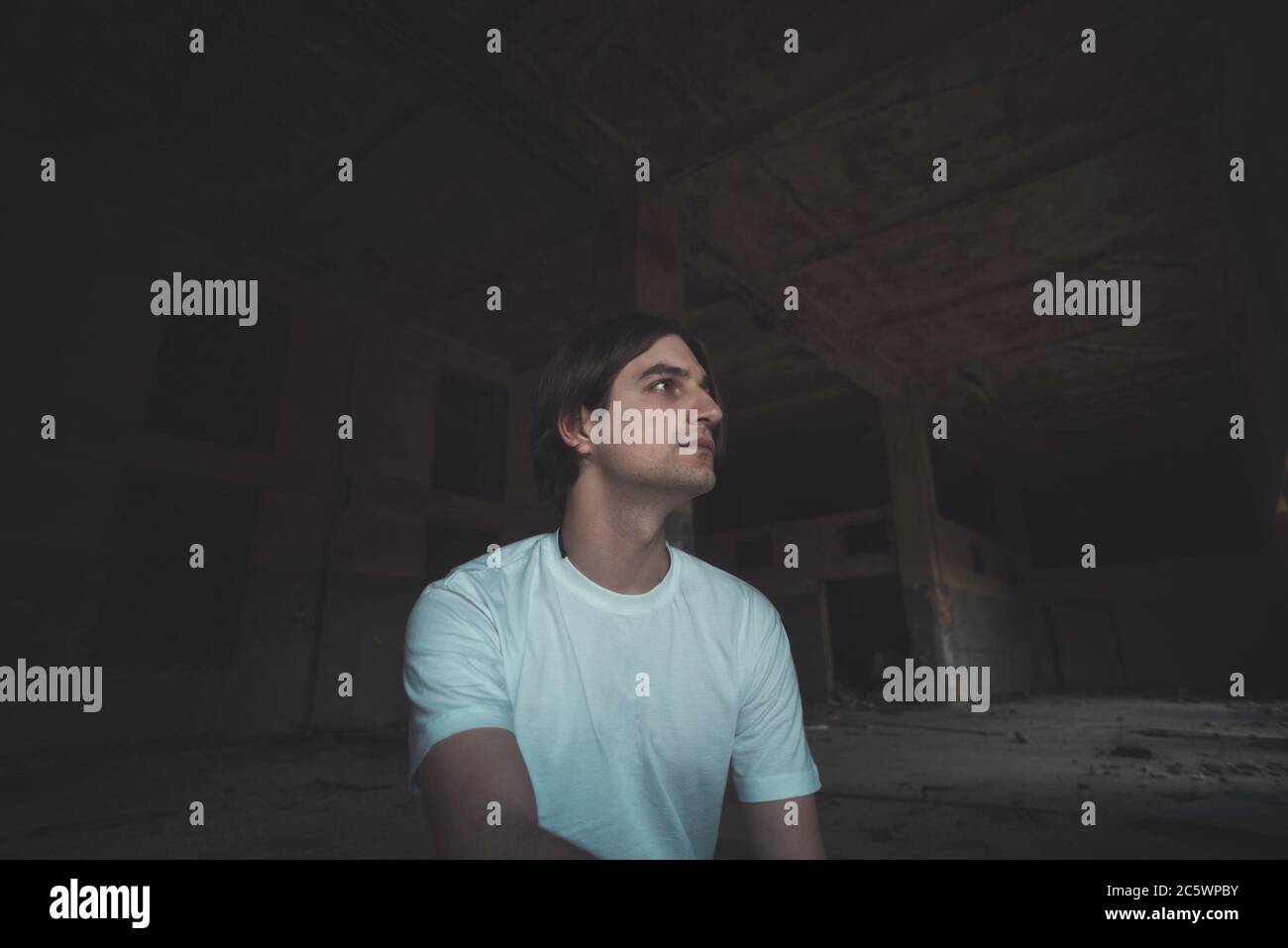 Young man posing in abandoned room Stock Photo