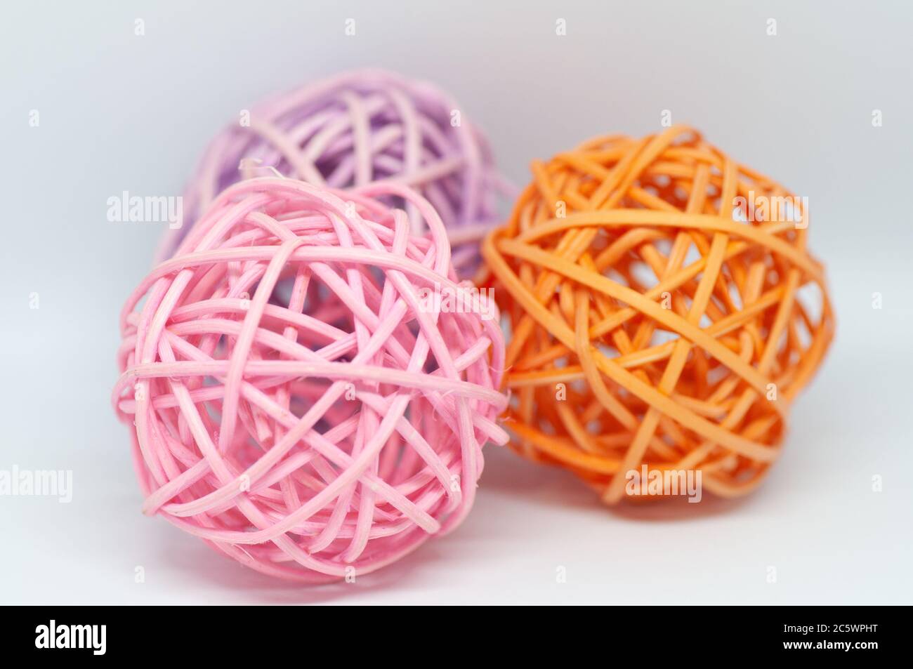 Dry reeds designed into three pink orange and lilac balls for ...