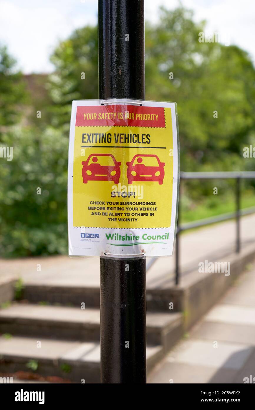 Information poster advising motorists how to maintain social distancing whilst exiting their vehicles during the Covid-19 pandemic Stock Photo
