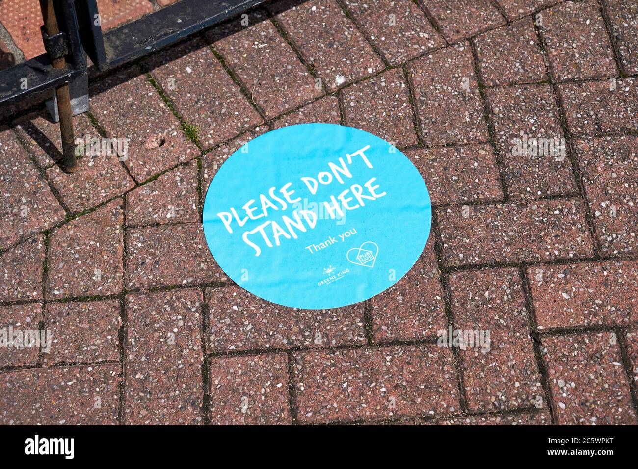 Please don't stand here sticker on pavement Stock Photo