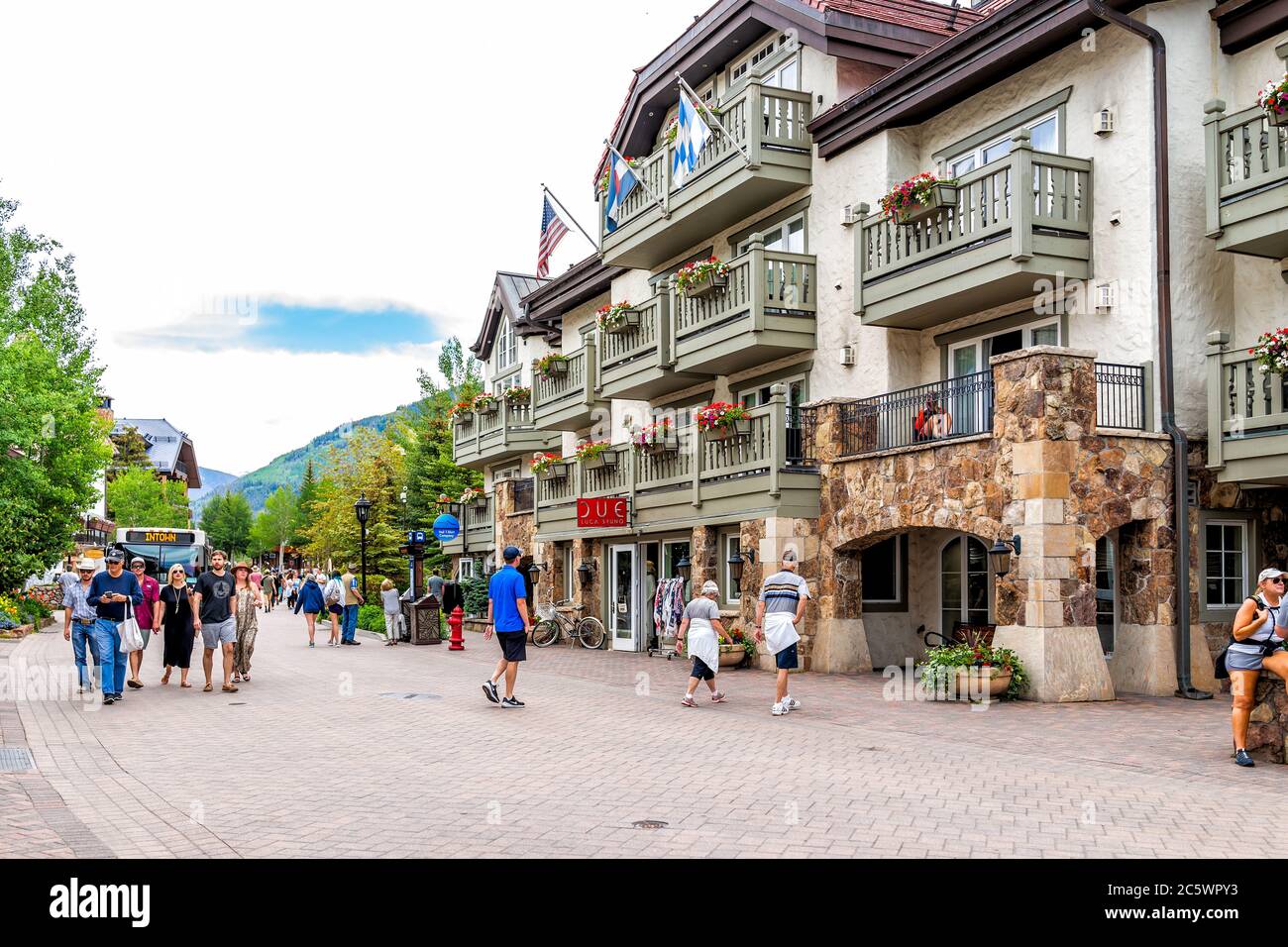 Vail, USA - June 29, 2019: People in center downtown Meadow drive street road with bus by stores and shops in Colorado ski resort town on western slop Stock Photo