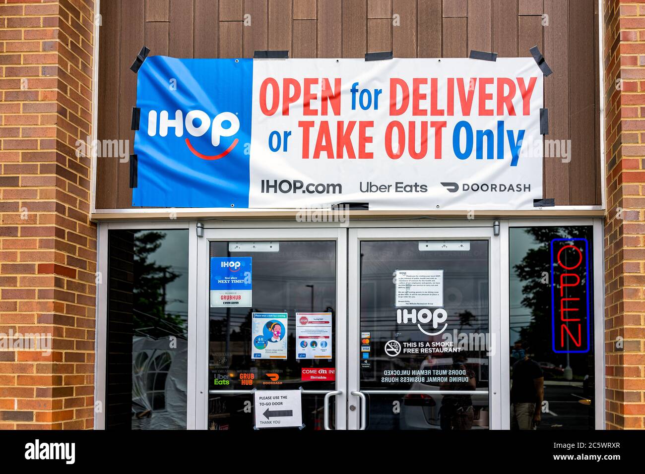 Herndon, USA - June 11, 2020: Virginia Fairfax County building entrance sign for open ihop restaurant for take-out and delivery during coronavirus Stock Photo