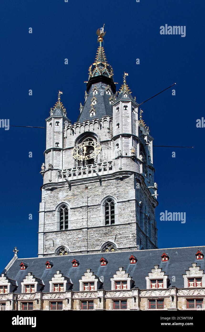 The Belfry; 298 feet ornate bell tower; 14 century; clock, spires, stone, UNESCO site, Cloth Hall in foreground; Lakenhalle; 15 century; Flanders, Eur Stock Photo