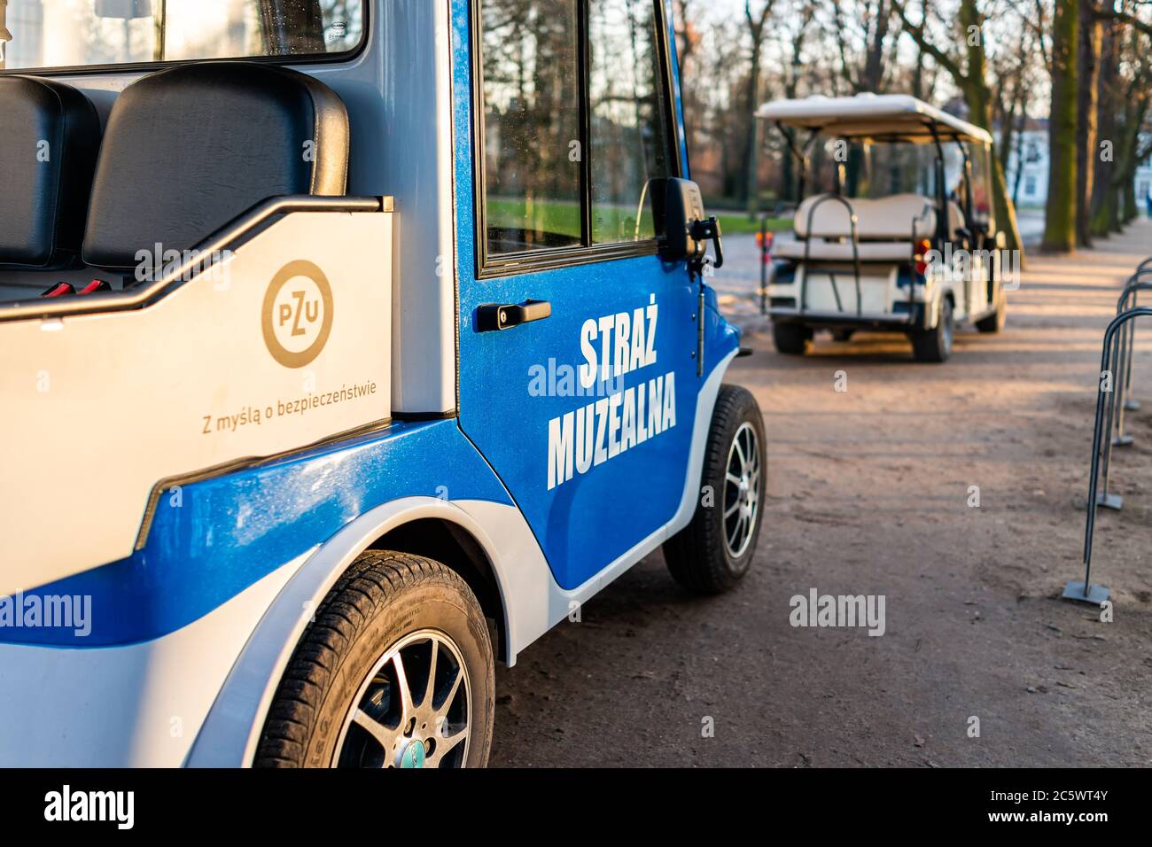 Warsaw, Poland - December 20, 2019: Warszawa Lazienki or Royal Baths Park with museum guards security golf carts cars sign blue color and nobody Stock Photo