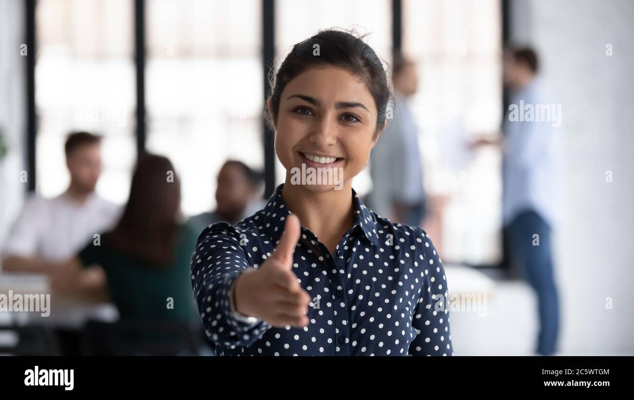 Friendly indian boss greeting client stretch out hand for handshake Stock Photo
