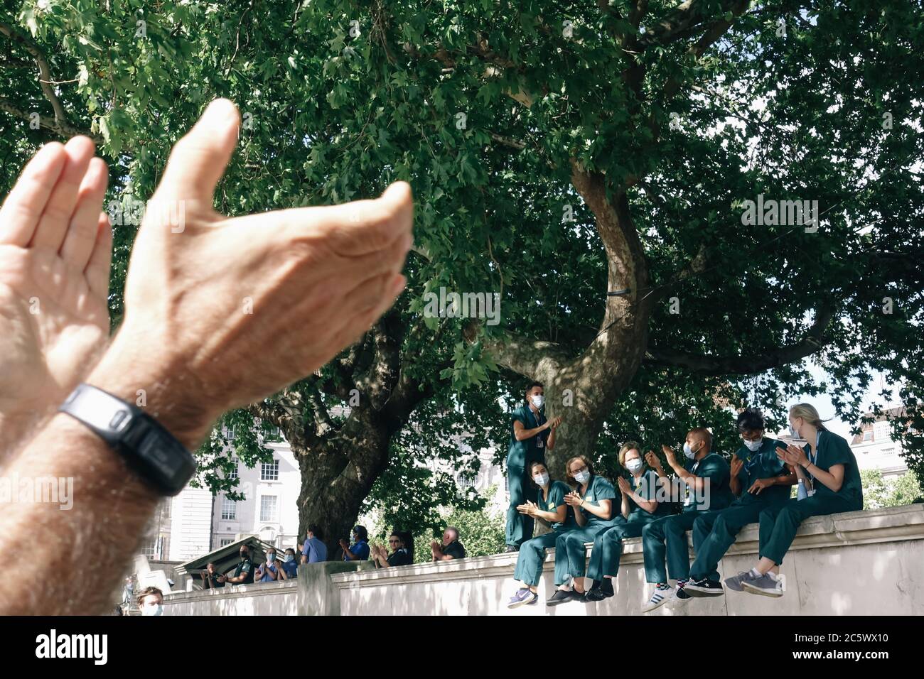 5th July 2020, NHS Staff gather outside St Thomas' Hospital in London to Clap for Carers on the 72nd Anniversary of the NHS. Stock Photo