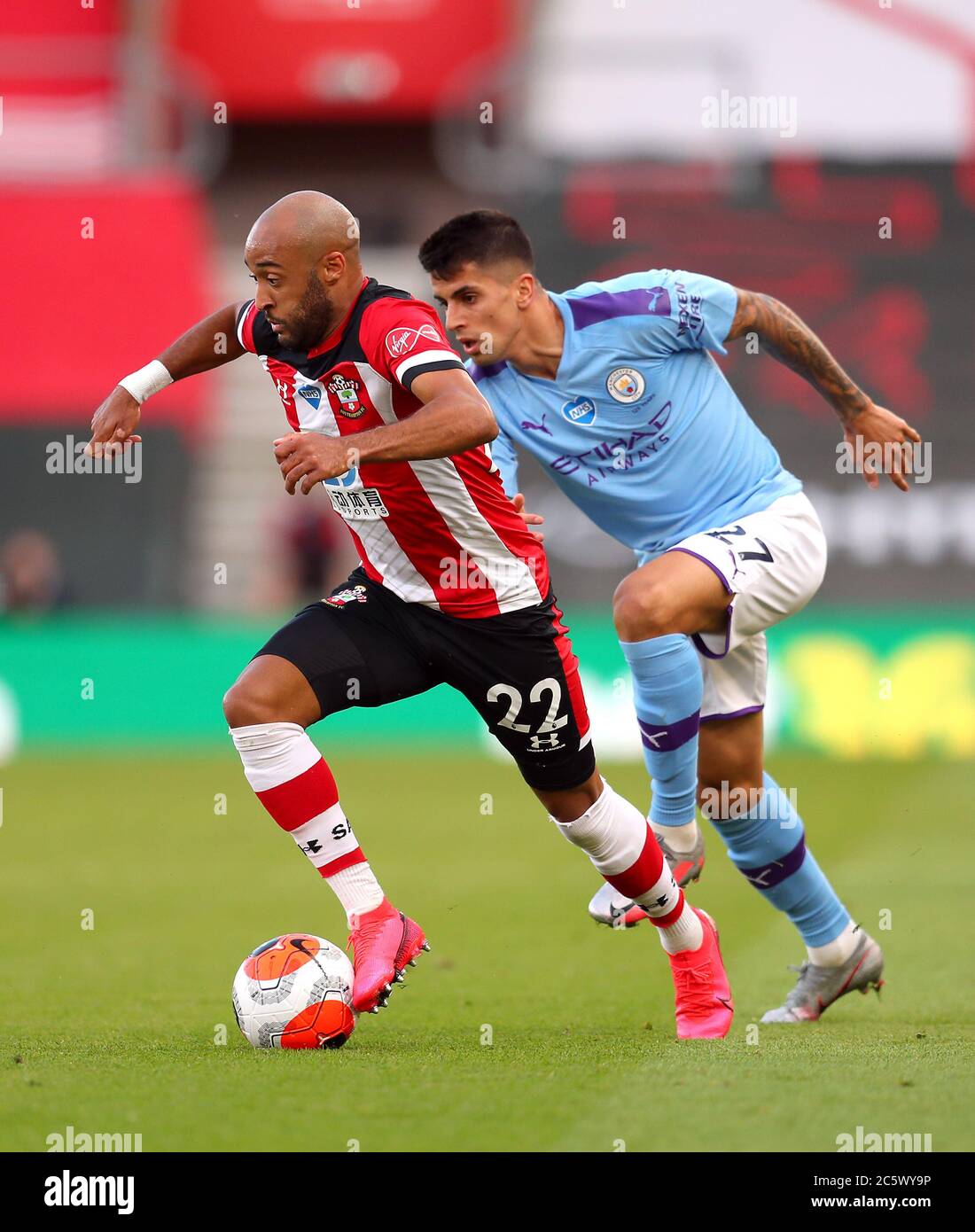 Southampton's Nathan Redmond (left) and Manchester City's Joao Cancelo battle for the ball during the Premier League match at St Mary's Stadium, Southampton. Stock Photo