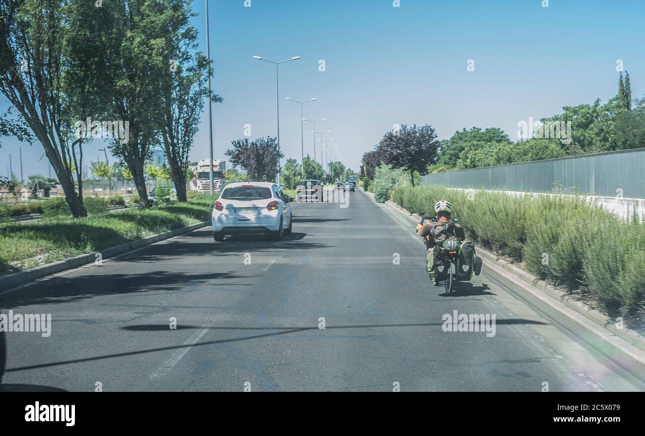 Driving slowly behind recumbent bicycle. View from the inside of the car Stock Photo