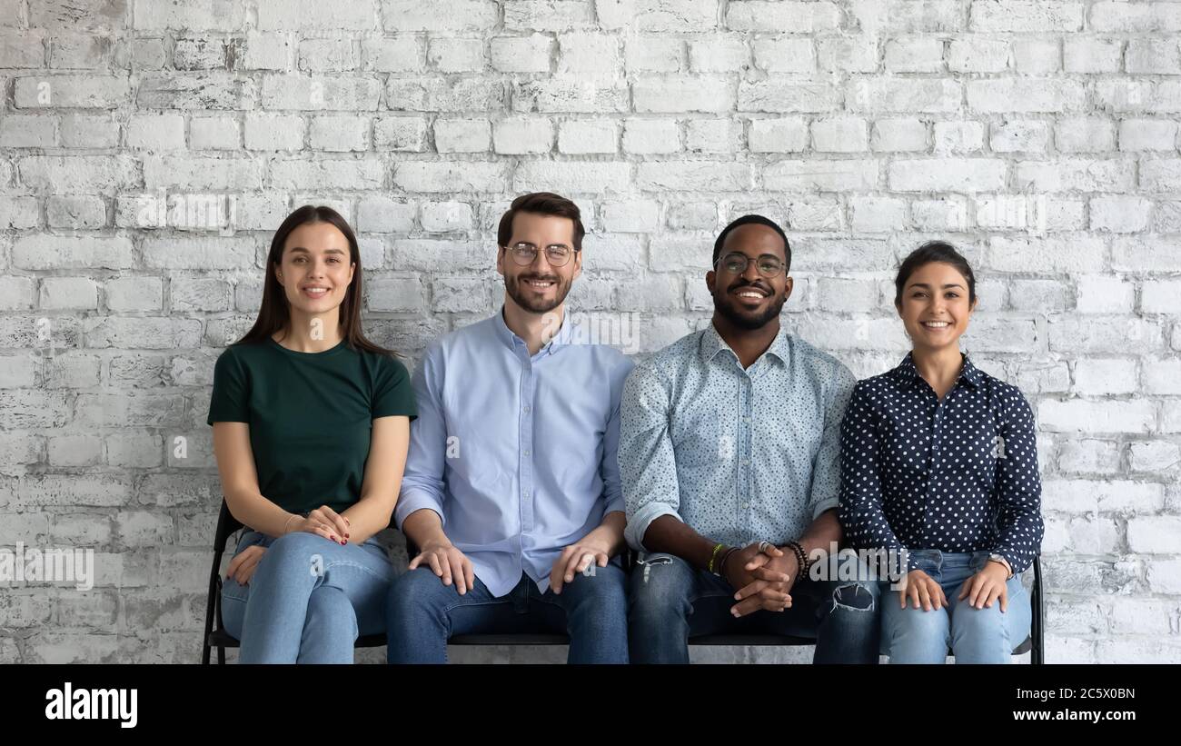 Wait Sit Multiethnic applicants sit on chairs wait turn for job interview Stock ...