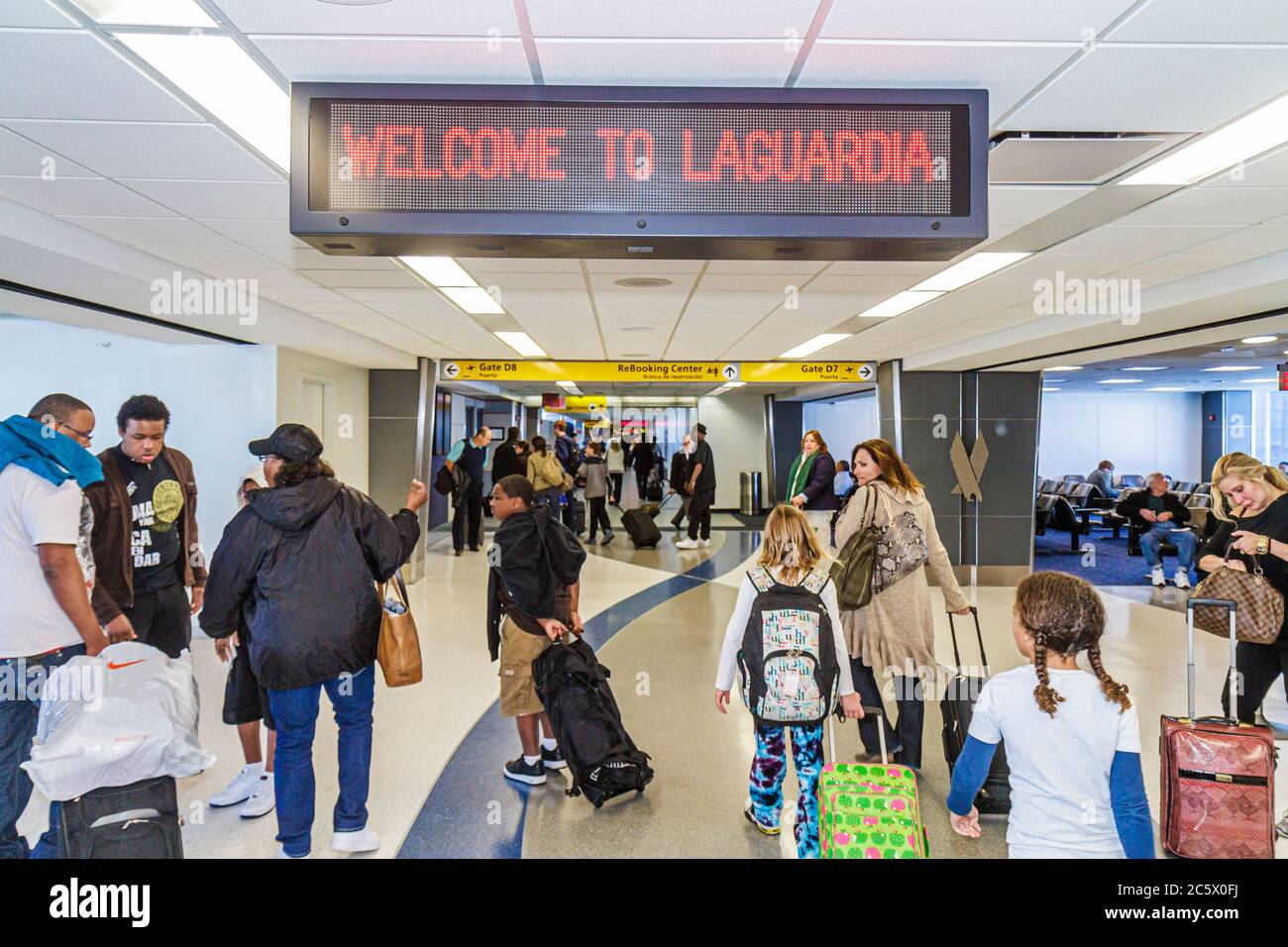 New York City,NYC NY Queens,LaGuardia Airport,LGA,terminal gate,passenger passengers rider riders,welcome LED sign,Black man men male adult adults,wom Stock Photo