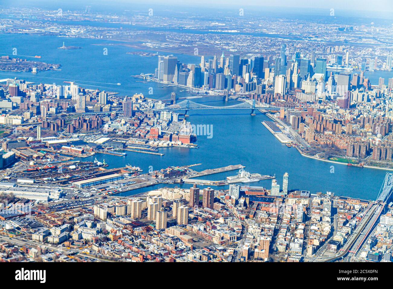 New York City,NYC LaGuardia Airport arriving flight,aerial overhead view from above,Brooklyn East Hudson River,Manhattan skyscrapers buildings skyline Stock Photo