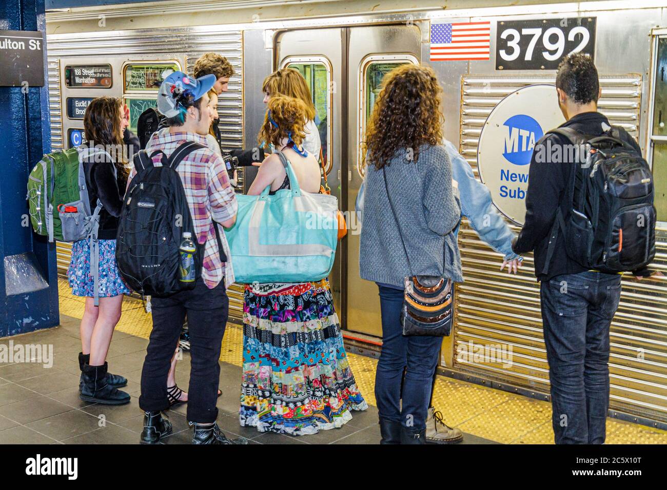 New York City,NYC NY Lower,Manhattan,MTA,subway,train,mass transport,Fulton Street Station,waiting platform,passenger passengers rider riders,girl gir Stock Photo