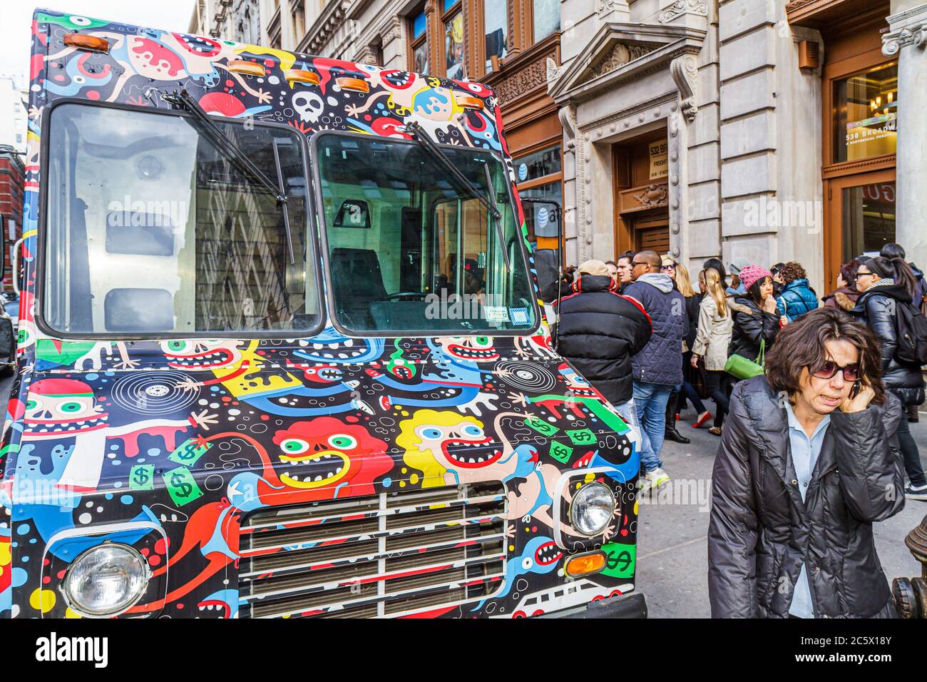 New York City,NYC NY Lower,Manhattan,SoHo,Broadway,parked delivery truck,van,commercial vehicle,wild paint job,cartoon figures,busy street,sidewalk,wo Stock Photo