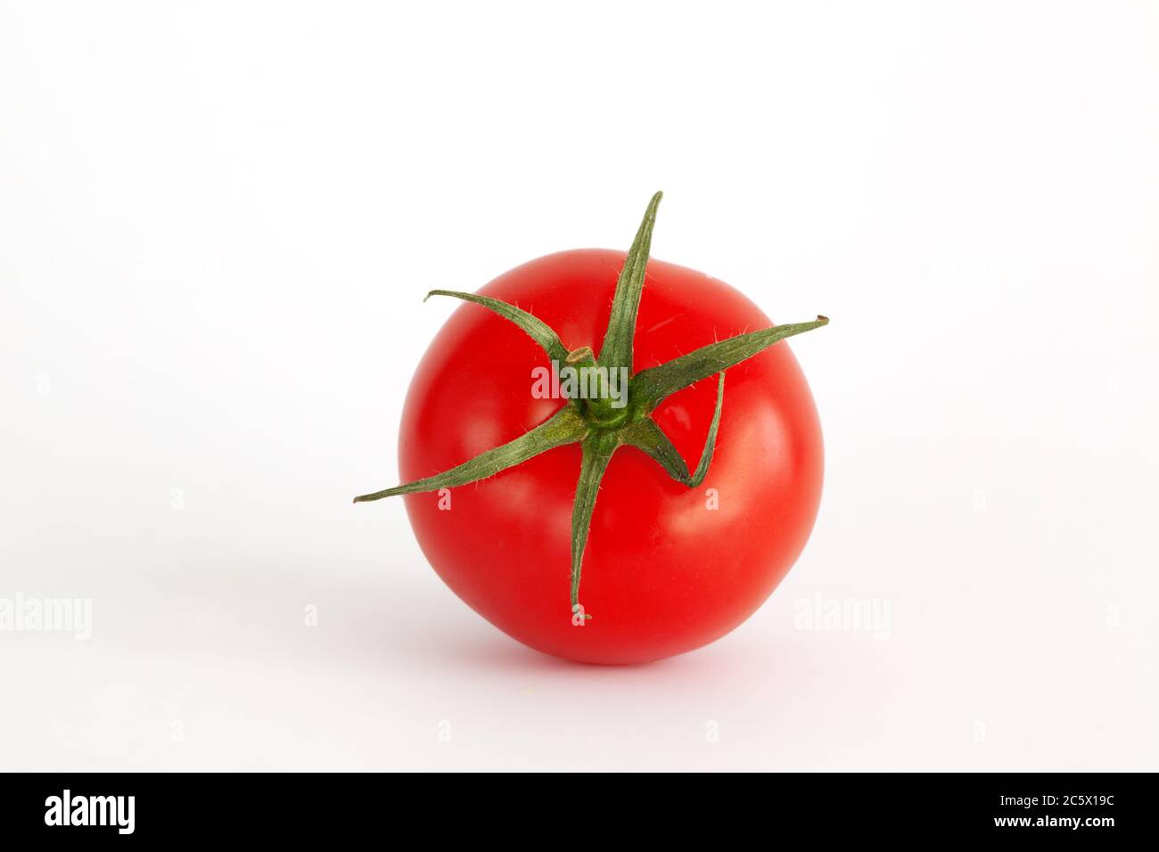 Isolated red tomato on white background Stock Photo - Alamy