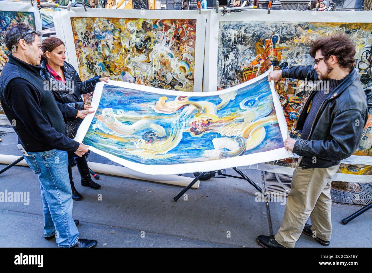 New York City,NYC NY Lower,Manhattan,SoHo,West Broadway,street,sidewalk,vendor vendors stall stalls booth market marketplace,art,painting,rolling,unfr Stock Photo