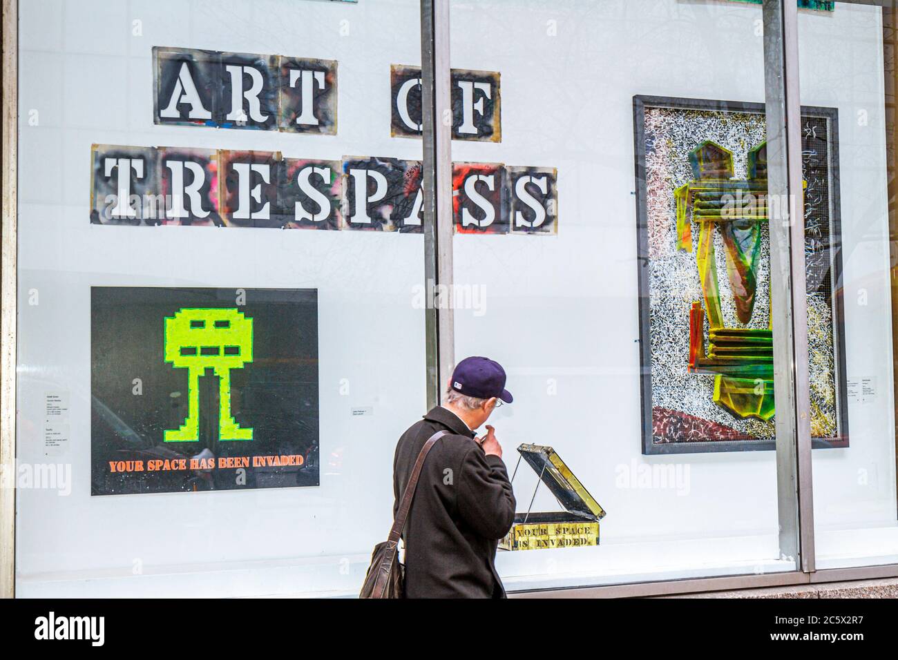 New York City,NYC NY Midtown,Manhattan,53rd Street,Donnell Library,window exhibit,installation,Art of Trespass,street artist,John Fekner,man men male Stock Photo