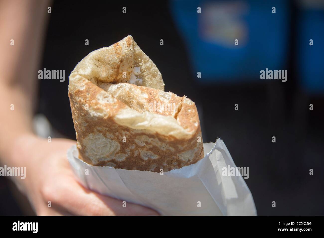 Hand holding a traditional rolled Druze Pita bread, Daliyat al-Karmel, Israel Stock Photo