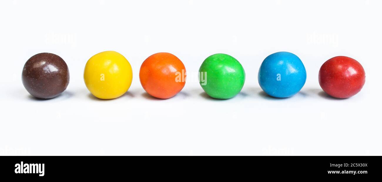 Chocolate covered balls isolated on white background. Colorful chocolate coated candies. Stock Photo
