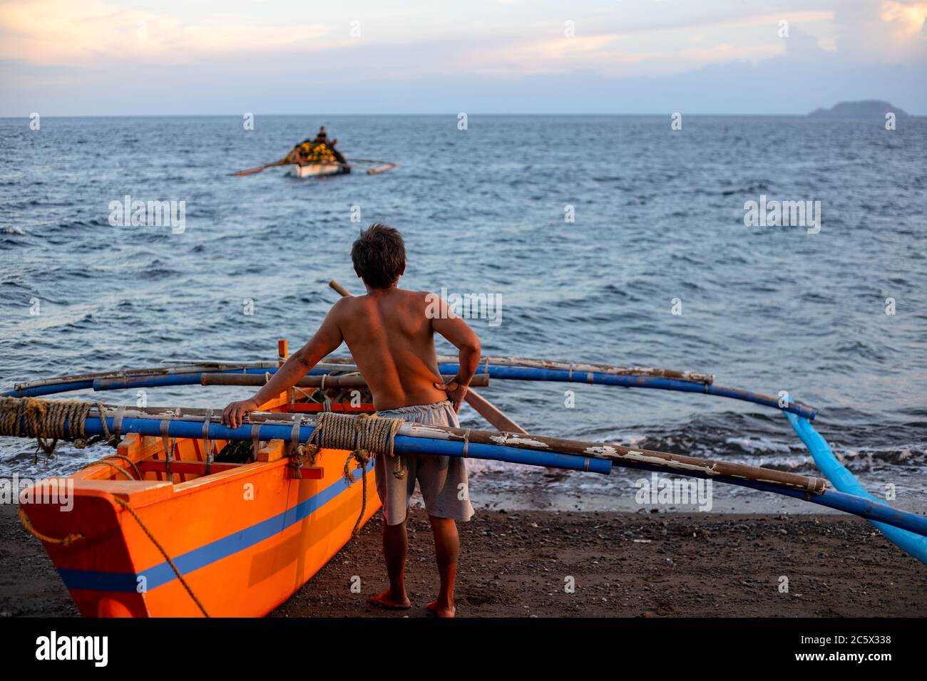 Dumaguete, the Philippines - 23 Mar 2020: local fishermen preparing for night fishing. Native lifestyle of filipino. Tropical island daily lifestyle. Stock Photo