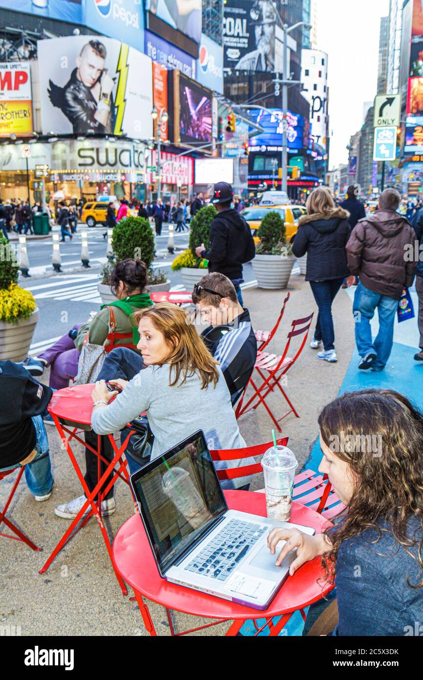 New York City,NYC NY Midtown,Manhattan,Times Square,Theatre District,woman female women adult adults,pedestrian plaza,table,outdoor hot spot,people wa Stock Photo