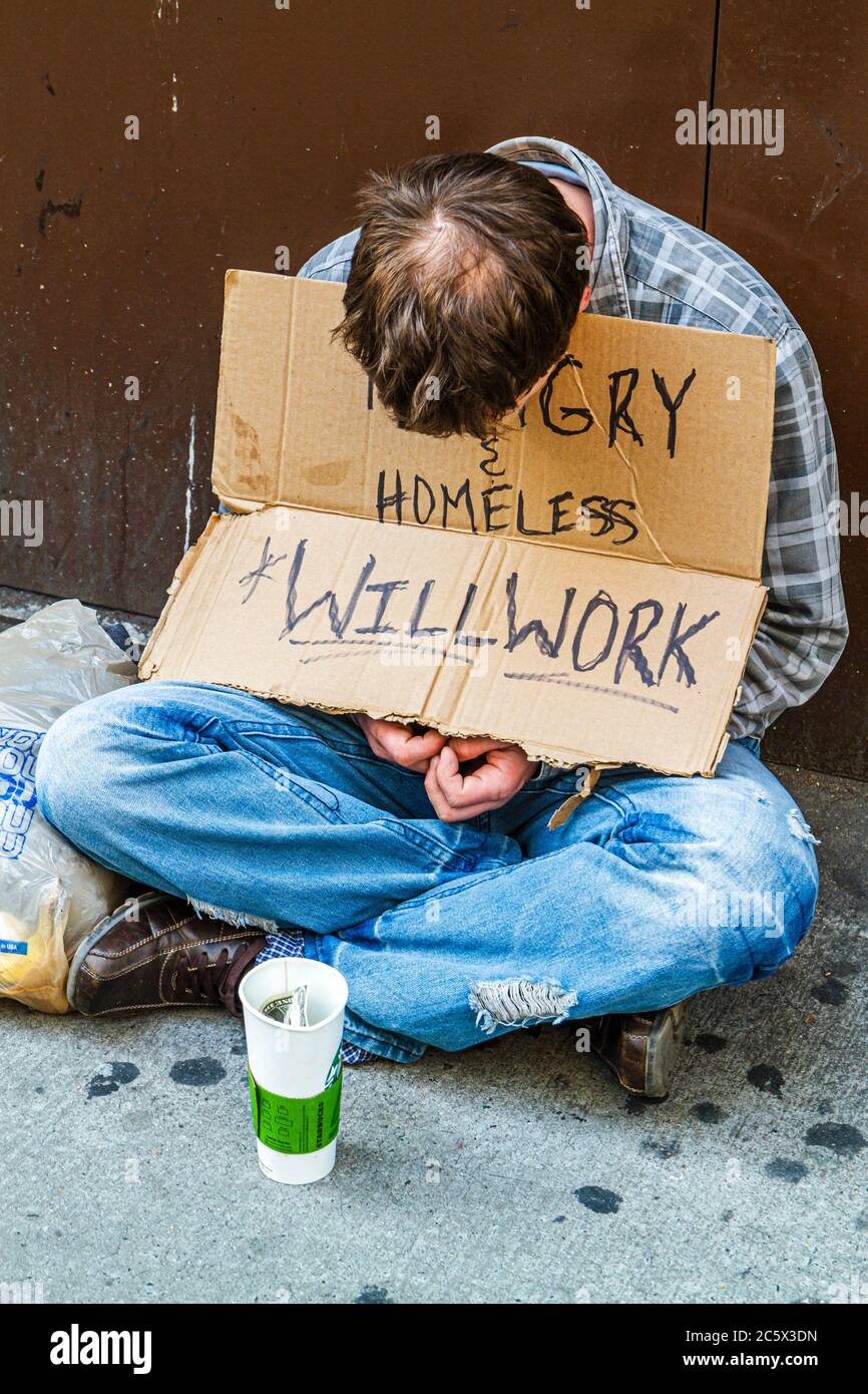 New York City,NYC NY Midtown,Manhattan,5th Fifth Avenue,man men male adult adults,vagrant,beggar,sign,homeless,hungry,will work,charity,torn jeans,pov Stock Photo
