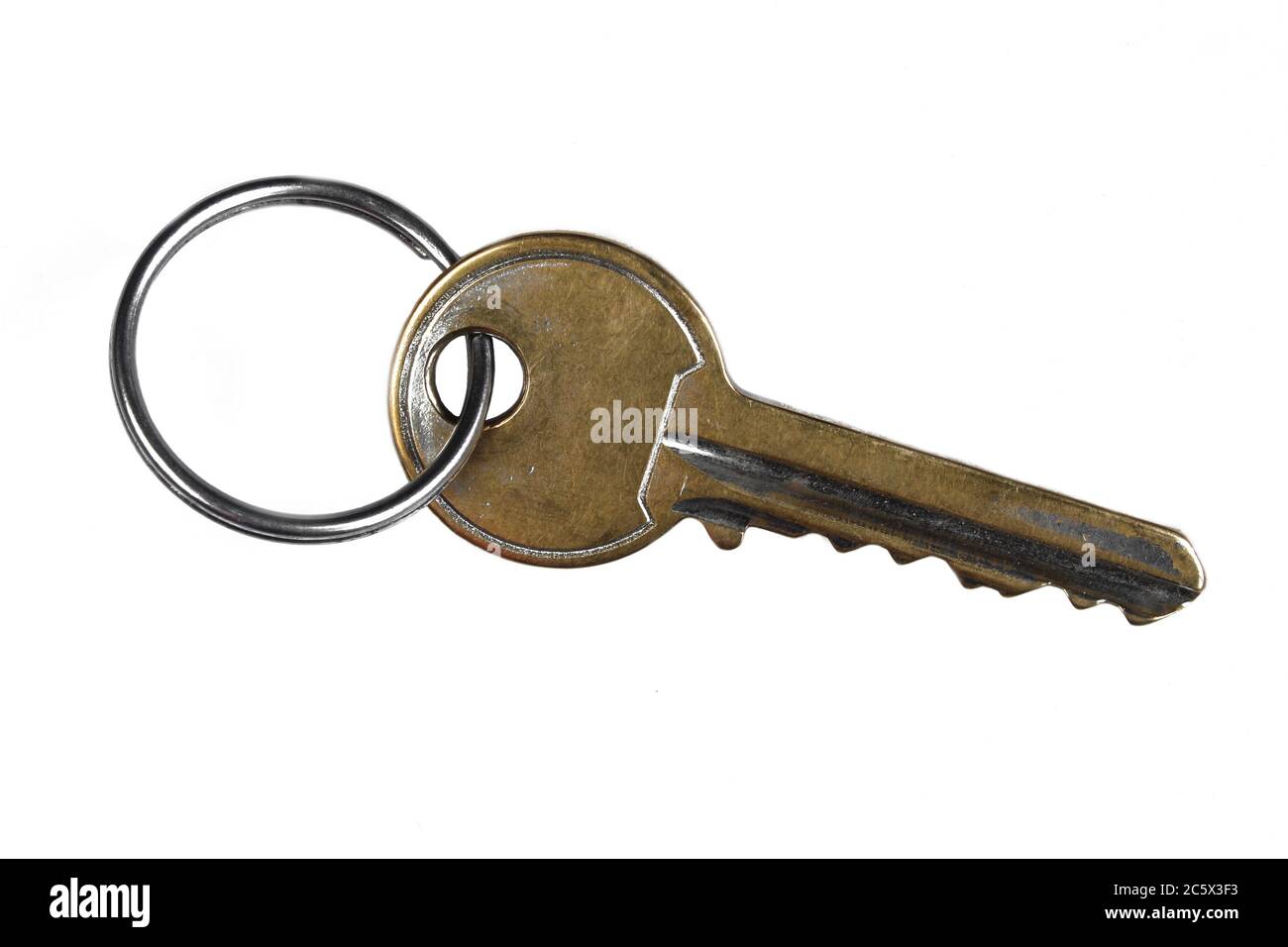 Old safety key isolated on white background. Used and damaged metal