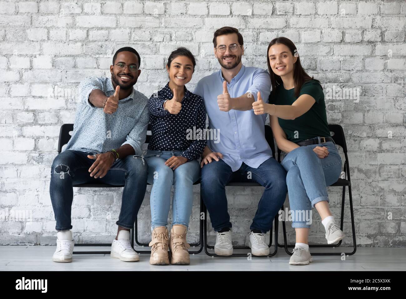 Applicants passed job interview getting position showing thumbs up Stock Photo
