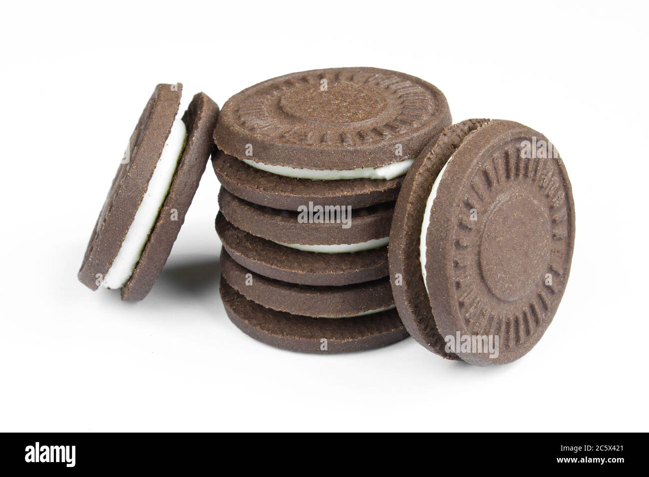 Stack of sandwich cookies with milk filling. Filled tea biscuits isolated on white background