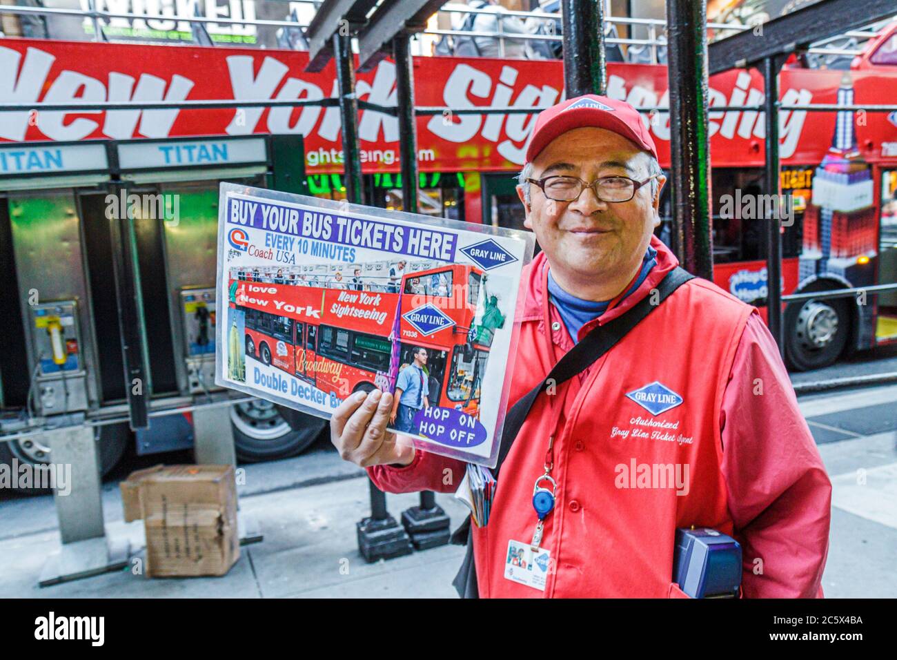 New York City,NY NYC Manhattan,Midtown,Times Square,Gray Line,double decker bus,coach,tour,driver,advertise,tickets,man men male adult adults,mature,v Stock Photo