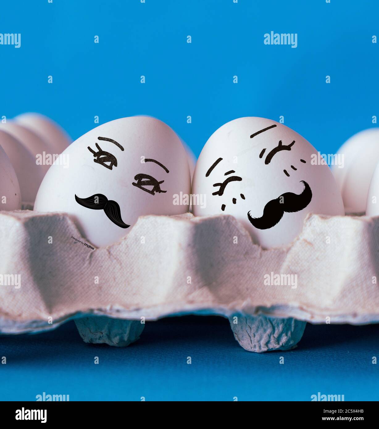 Faces on the eggs, gay couple in love concept with blue background Stock Photo