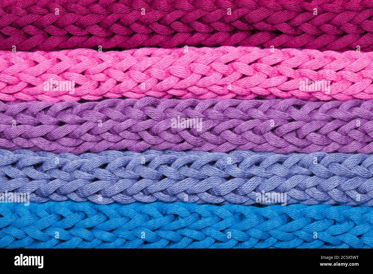 Macro horizontal rows of multicolor woven braids Stock Photo